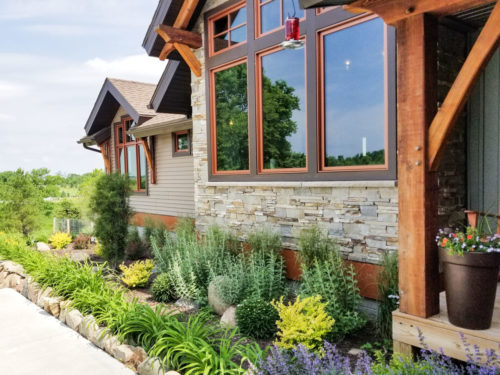 Exterior details of home including large window and stone