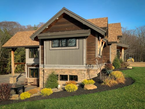 Side shot of home with mix of materials include steel siding and big timber